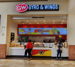 Customers ordering food at mall food court Gyro and Wings franchise