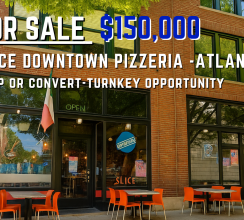 Street-level view of SLICE Downtown Pizzeria, a restaurant for sale in Atlanta, GA, with a brick façade, floor-to-ceiling windows, outdoor seating with orange chairs, and a vertical “SLICE” sign—presented by Jimmy Carey Commercial Real Estate, Atlanta Restaurant Business Broker.